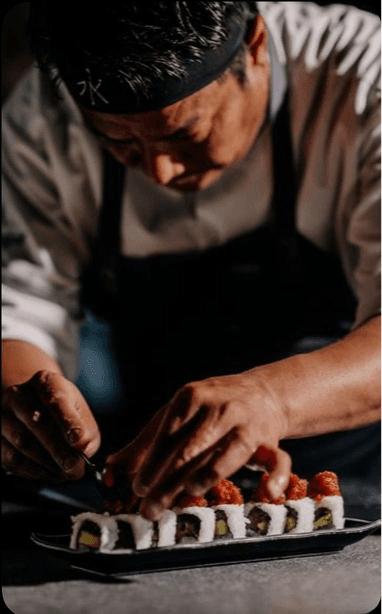 Chef Don Muñoz plating sushi at the counter.