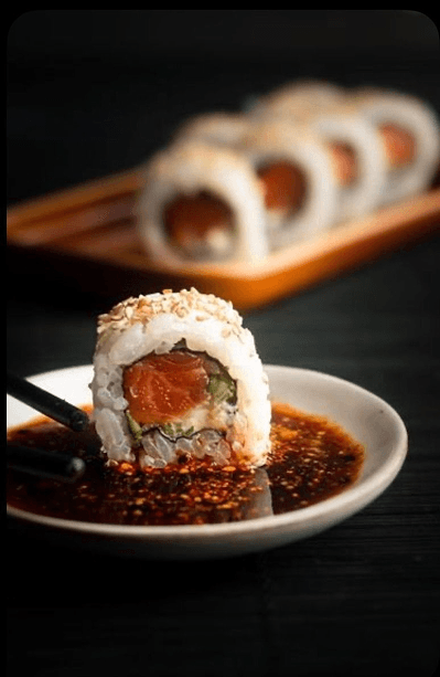 A signature salmon roll served with dipping sauce.